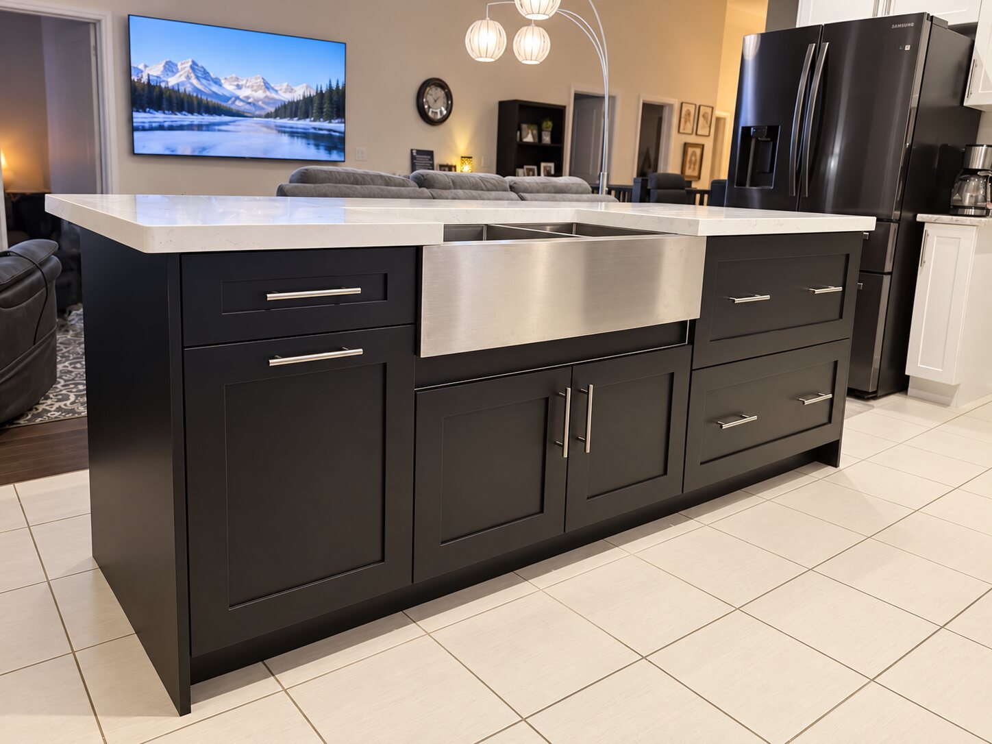 Black Shaker kitchen island with white quartz countertop, stainless-steel apron-front sink and brushed metal hardware