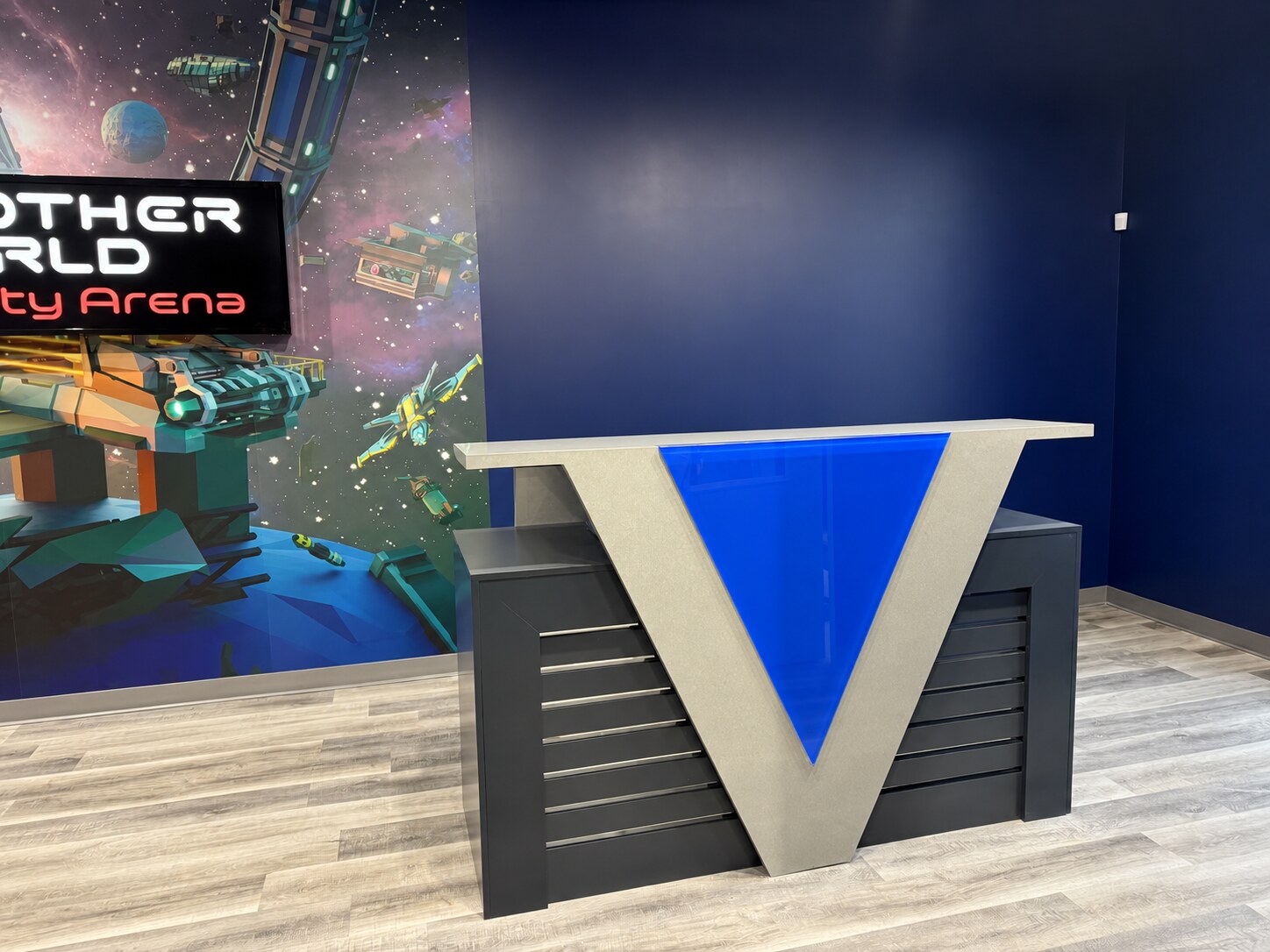 Completed commercial reception desk with geometric front panel, integrated drawers and transaction counter